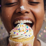 Person holding a cupcake candle.