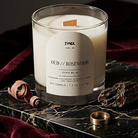best oud candle Candle on marble with decorative elements. best oud candle