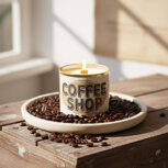 Candle surrounded by coffee beans.