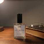 Pdriftwood fragrance erfume bottle on wooden table
