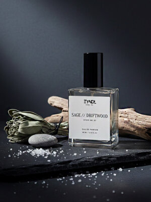 iced bergamot and driftwood Fragrance bottle with natural elements.
