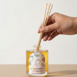 Hand placing reeds in diffuser