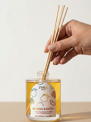 Hand placing reeds in diffuser