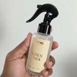 Hand holding cereal milk linen spray