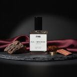 Bottle of oud perfume with wood