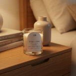Candle on wooden nightstand with decor