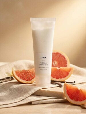 Grapefruit lotion with fresh citrus and vanilla ingredients lifestyle scene
