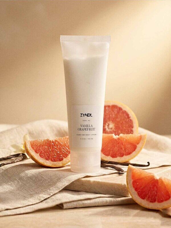 Grapefruit lotion with fresh citrus and vanilla ingredients lifestyle scene