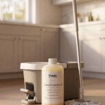 Lemon and Sandalwood Floor Cleaner. lemon scented cleaning products with mp bucket and mop on the floor.